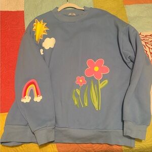 Blue Sweatshirt with Colorful Appliques